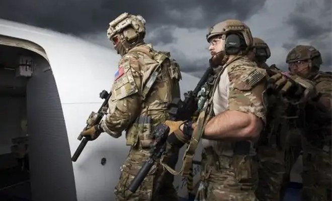 Military members carrying slinged rifles.