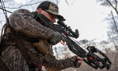 A hunter aiming with a crossbow.