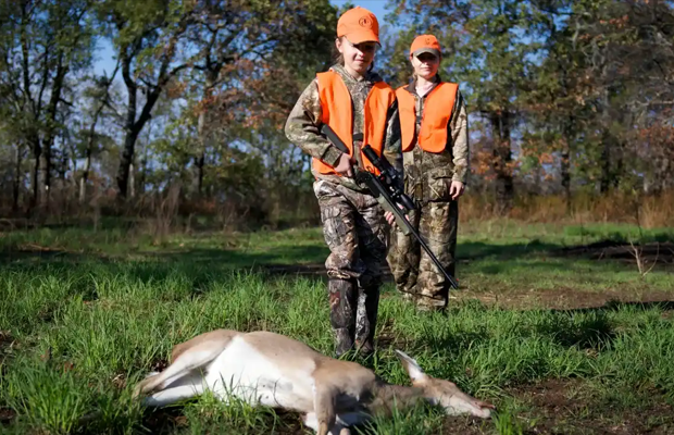 Young hunters with a deer.