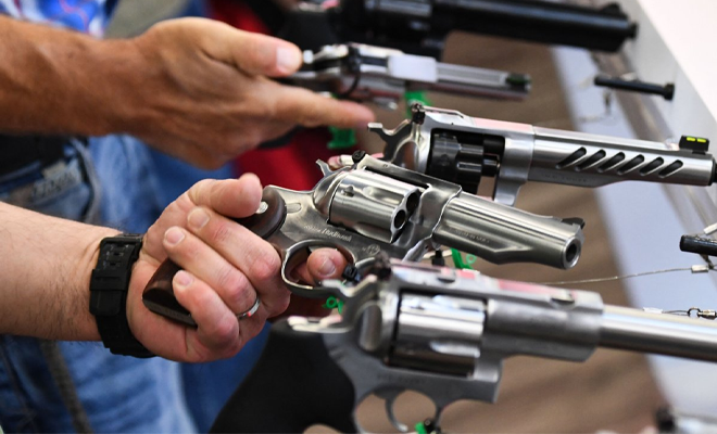 Prople buying guns at a store.