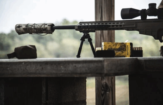 A rifle with a Suppressor and Suppressor Cover