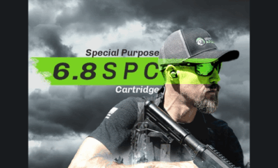 A man holding a black rifle.