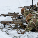 U.S. Paratroopers shooting rifles from the prone position.