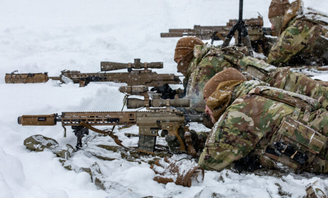 U.S. Paratroopers shooting rifles from the prone position.