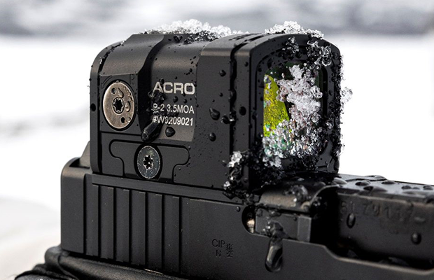 A handgun with a red dot sight.