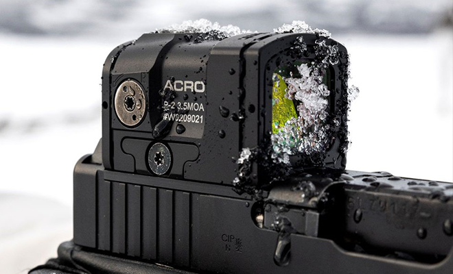 A handgun with a red dot sight.