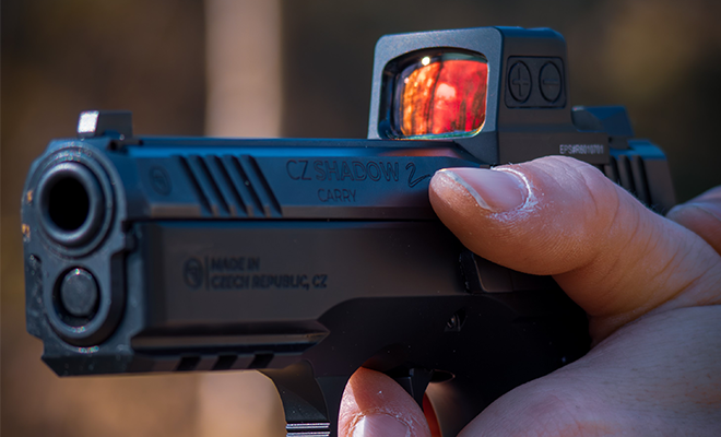 A gun with a red dot sight.